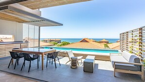 A terrace with a pool, outdoor seating, and a view of the sea. - Zimbali by Euphoric, Zimbali Coastal Resort, Ballito (Ballito)