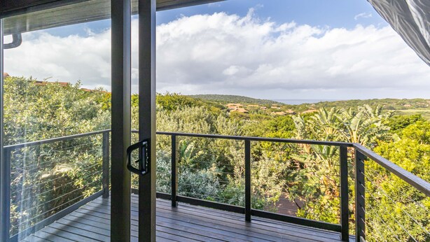 A balcony with a view of a lush landscape, including trees and hills. - Zimbali by Euphoric, Zimbali Coastal Resort, Ballito (Ballito)