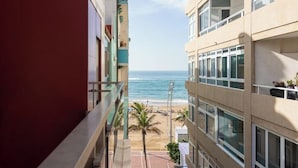 A high-rise building with balconies overlooking a beach. - Silken Atlantis Playa – Holiday Homes (Las Palmas de Gran Canaria)