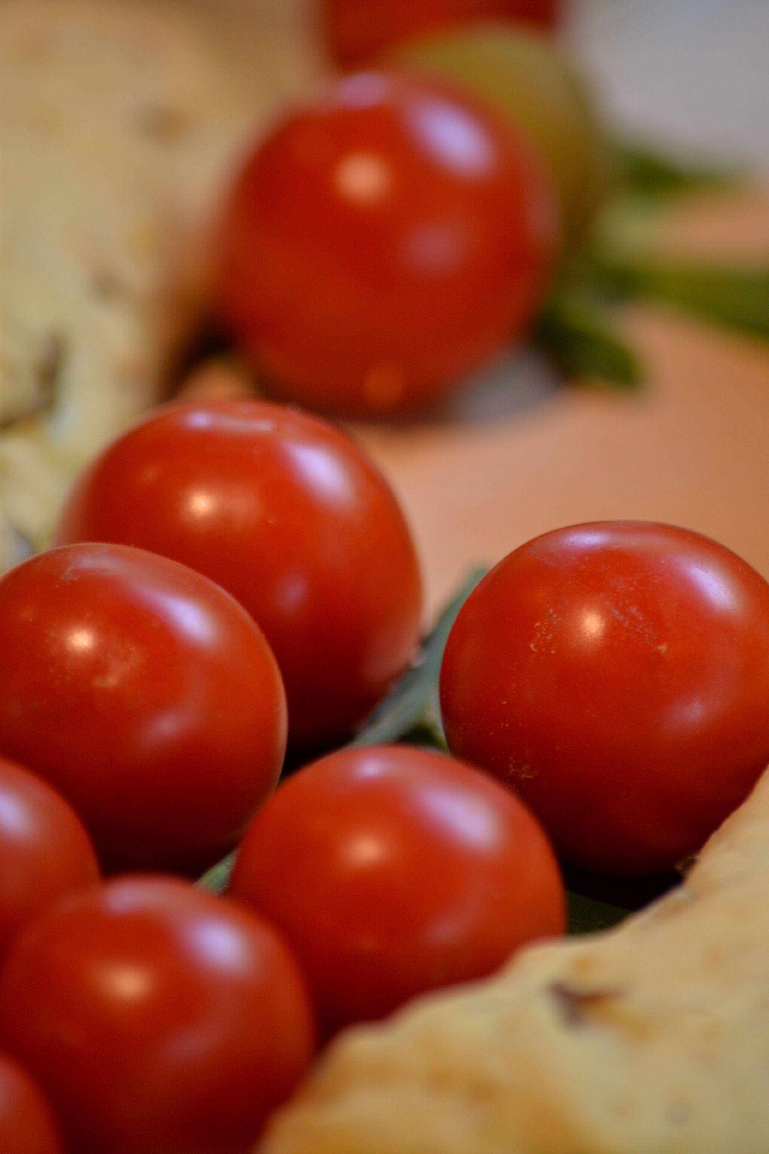A close-up of cherry tomatoes on a wooden surface.