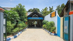 A pathway leading to a building with a sign reading "Home Stay Wallet." - Hotel O Wallet Family Residence Syariah (Lumajang)
