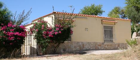 A single-story building with a stone foundation and a tiled roof.