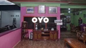 A living room with a TV stand, a wooden cabinet, and a sofa.