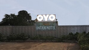 A motel sign with the name "OYO INTAN MOTEL" and a logo.