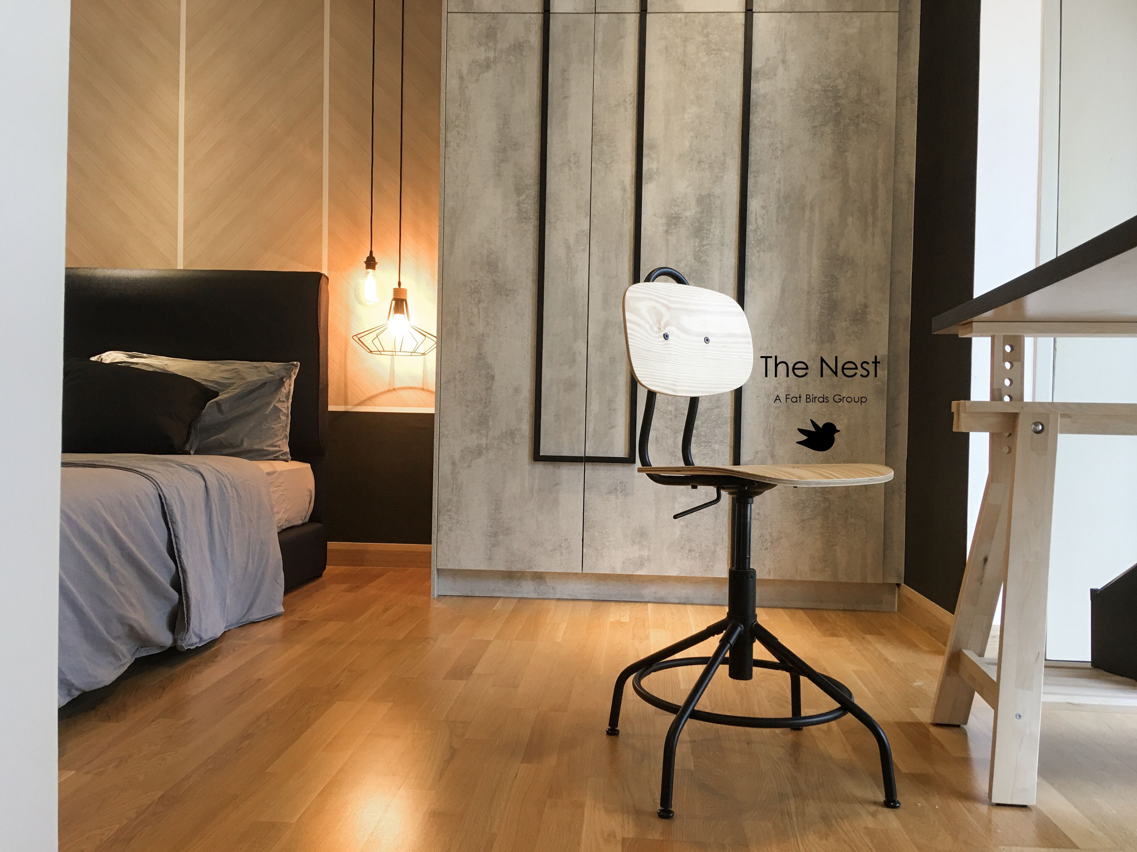 A modern room with a bed, a unique chair, and a wall-mounted light fixture.