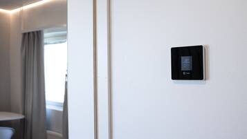 A thermostat on a wall, indicating a temperature of 22.5°C.