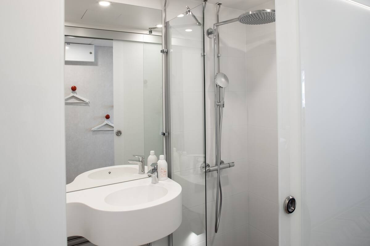 standard single room | bathroom | shower, rainfall showerhead, hair dryer, heated floors