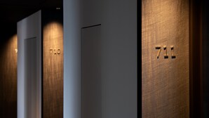 A hallway with doors numbered 710 and 711, indicating a hotel setting. - Prince Smart Inn Ebisu (Tokyo)
