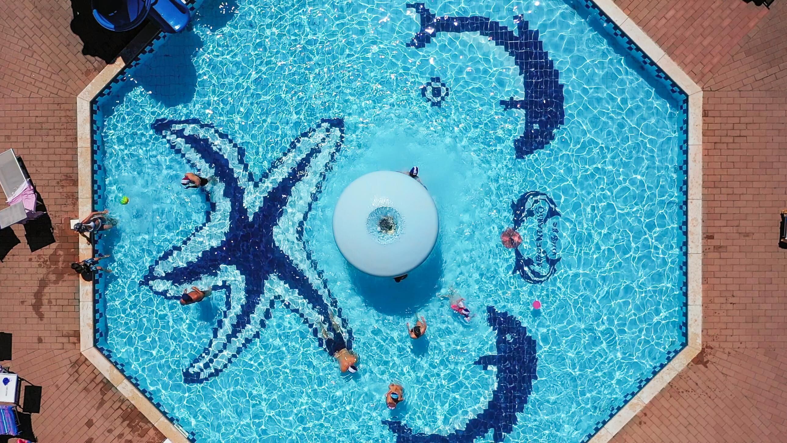 An octagonal pool with a central fountain, surrounded by a tiled deck.