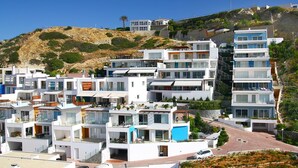 A modern residential area with multi-story buildings featuring balconies and terraces.