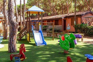 A playground with a slide, swings, and a climbing structure.