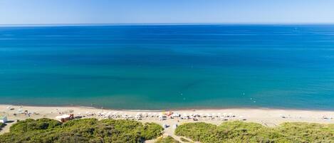 Private beach, black sand, sun loungers, beach umbrellas
