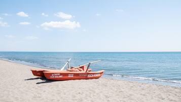 Private beach, black sand, sun loungers, beach umbrellas