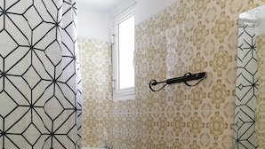 A bathroom with a toilet, sink, and shower curtain. - Andreas Cozy Lovely House (Heraklion)