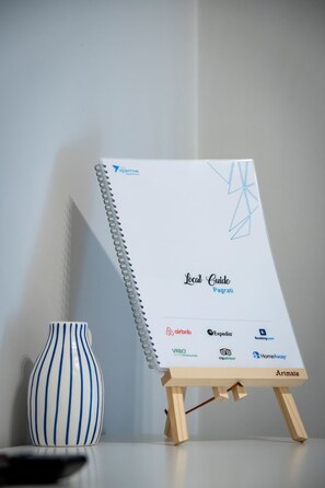A spiral-bound local guide for Pagratiti with logos of travel and accommodation services.