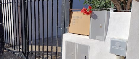 A gated entrance with a mailbox and a utility box.