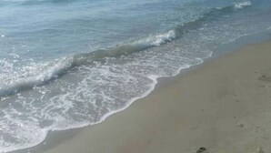 A beach with waves gently lapping onto the shore. - Always on Foot 3 min to the Beach Center With Double Terrace (Tertenia)