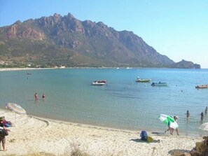 A beach with clear waters, boats, and mountains in the background. - Always on Foot 3 min to the Beach Center With Double Terrace (Tertenia)