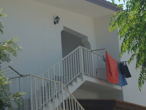 A multi-level building with a staircase and a balcony.