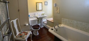 A bathroom with a toilet, sink, and bathtub.