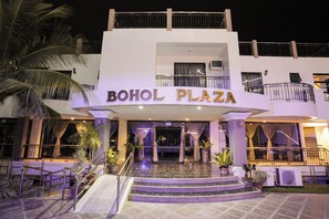 The exterior of BOHOL PLAZA with a prominent entrance, steps leading up to the main door, and a balcony on the upper floor. - Bohol Plaza Resort and Restaurant (Dauis)