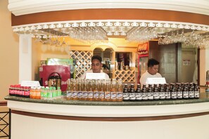 A bar area with a counter displaying various beverages and a Coca-Cola refrigerator. - Bohol Plaza Resort and Restaurant (Dauis)