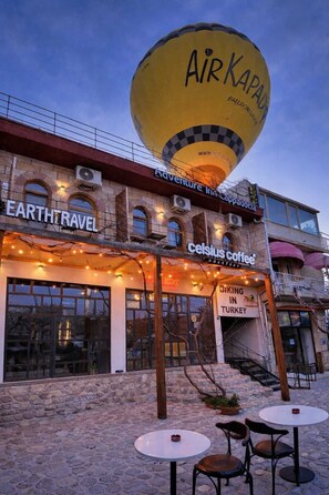 A building with a large hot air balloon, a coffee shop named Celsius Coffee, and a sign for Earth Travel.