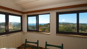 A room with three large windows, a table, and two chairs. - Apartment 2003/28453 (Istria - Premantura), 500m from the beach (Premantura)