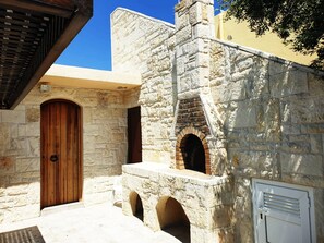 A stone building with a wooden door and arched windows. - Traditional House Spectacular View near Heraklion (Malevizi)