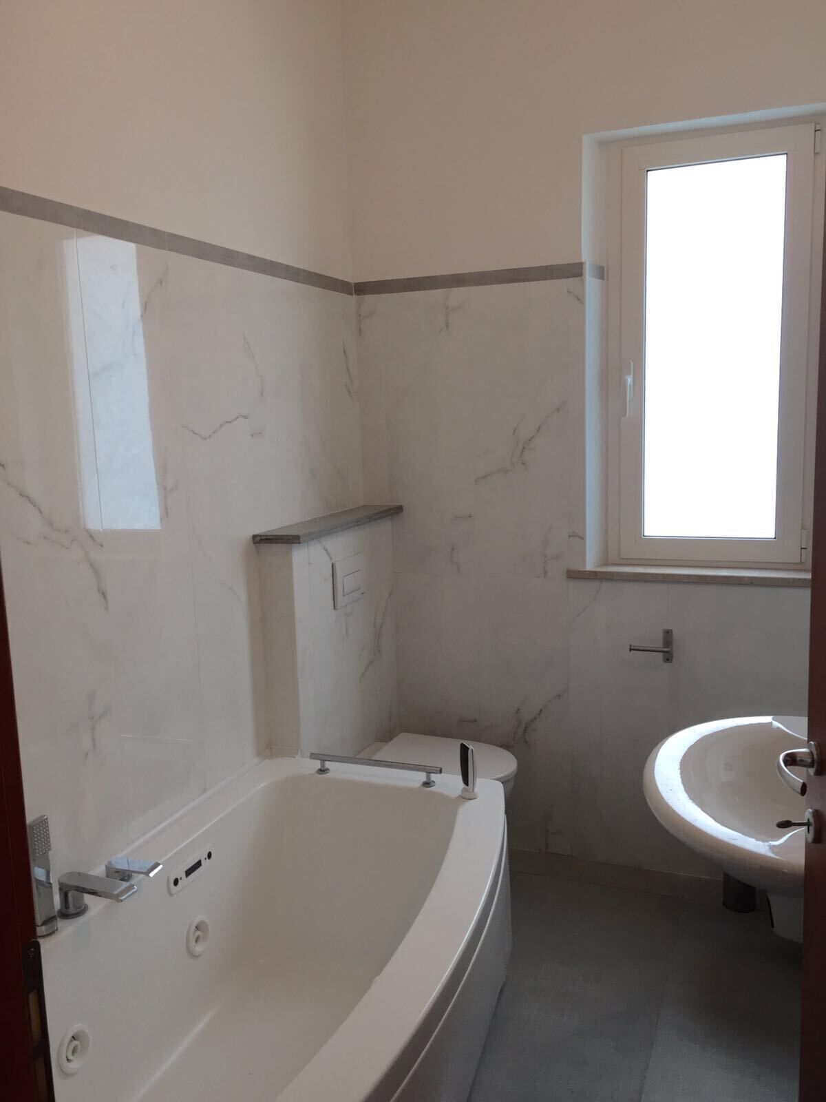 A bathroom with a bathtub, toilet, and sink.