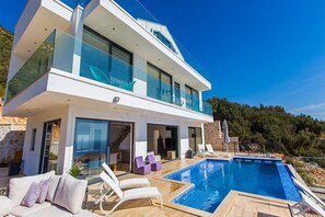 An infinity pool, pool loungers