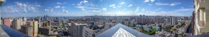A panoramic view of a cityscape with high-rise buildings, a clear sky, and a distant coastline. - Panorama Baku - 22 Floor (Baku)