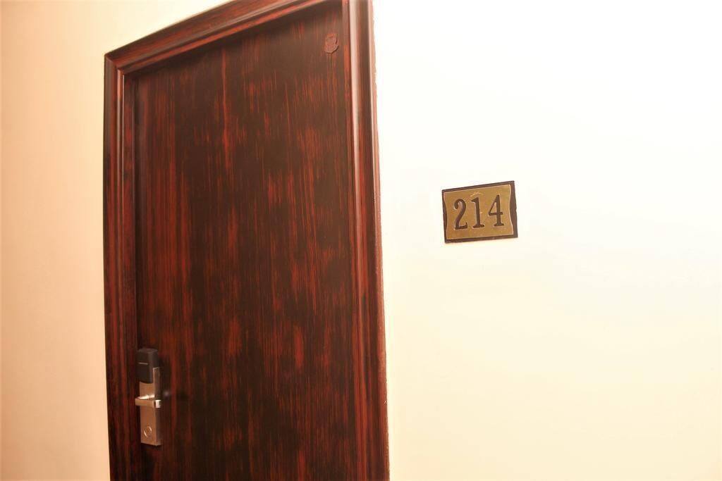 A wooden door with a number plate indicating room 214.
