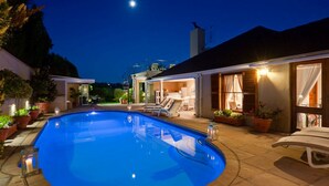 A swimming pool with lounge chairs and a covered patio area. - Lavender Cottage 2 Double Bedrooms 2 Bathrooms both on suite Beautiful Views (Cape Town)