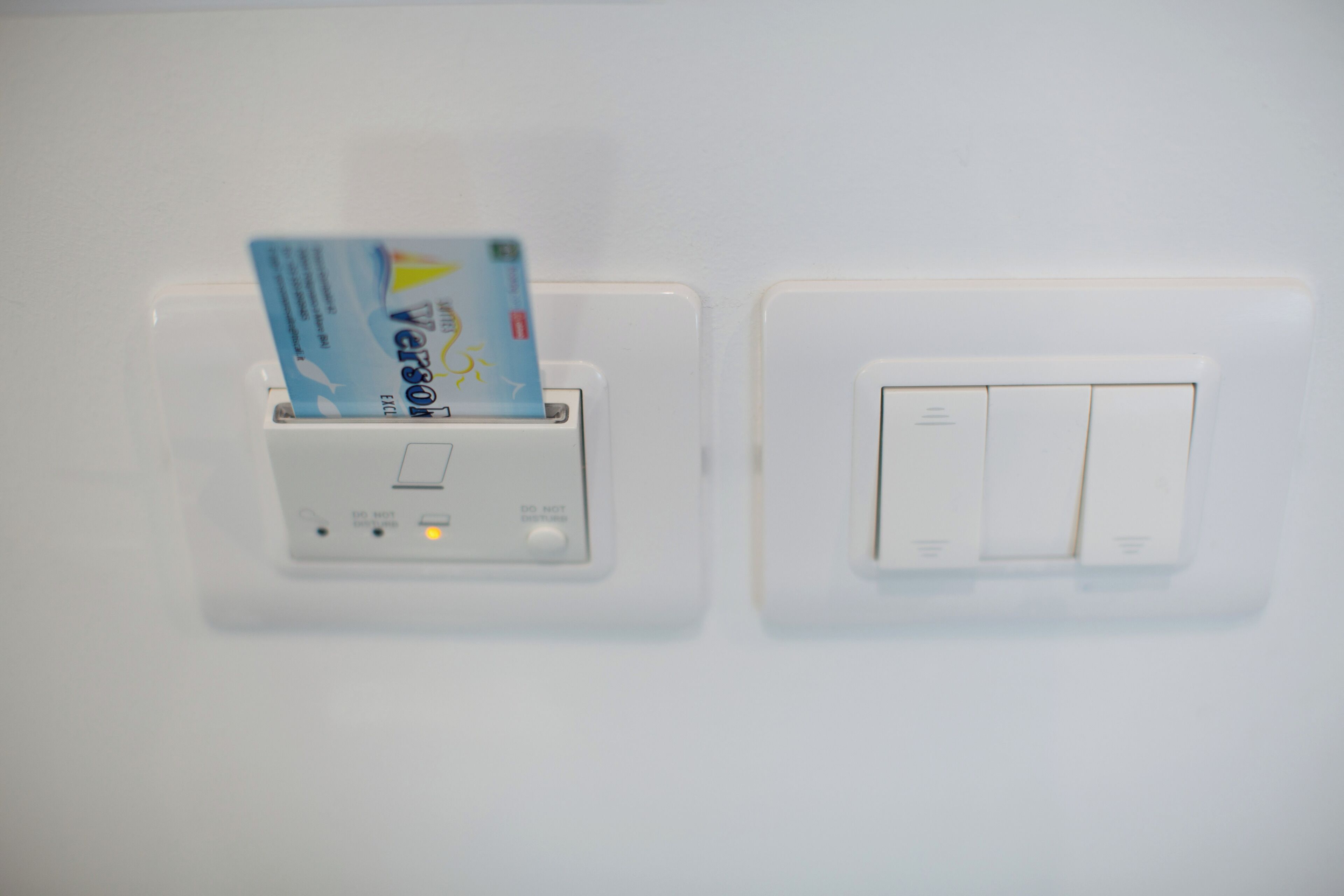 A wall-mounted card reader and a light switch.
