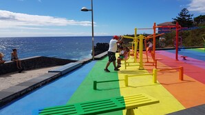 A playground with colorful equipment and a view of the ocean. - Room-the Magic Dragonfly! (Candelaria)