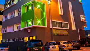 A multi-story hotel building with a neon sign reading "De Spring" and "HOTEL" on the facade. - De Spring Hotel (Kuantan)