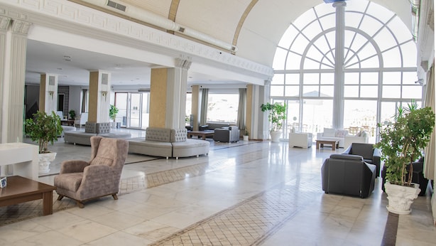 A spacious lobby with a high ceiling, large windows, and modern furniture. - Phoenix Sun Hotel (Bodrum)