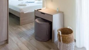 A modern hotel room with a bed, bedside table, lamp, and a large mirror. - Coastal Dreamy Retreat, Dive in Dimitra's Paradise (Finikounta)