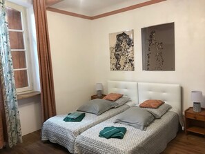 Cozy retreat with a double bed, two bedside tables, and wall art.