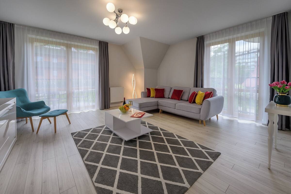 A modern living room with a sofa, a coffee table, and a chair.