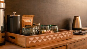 A coffee maker, a bag of Grizzly Blend coffee, and glass jars on a wooden tray. - Relax in your own secluded Yurt Cabin nestled into a 200+ acre Property! (Bastrop)