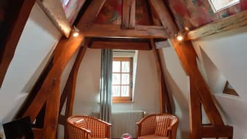 Comfort Room (Le Grenier aux Fleurs) | Laptop workspace, blackout drapes, iron/ironing board