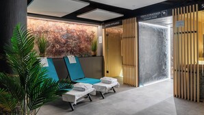 A modern spa area with a sauna, infrared therapy room, and relaxation lounges.