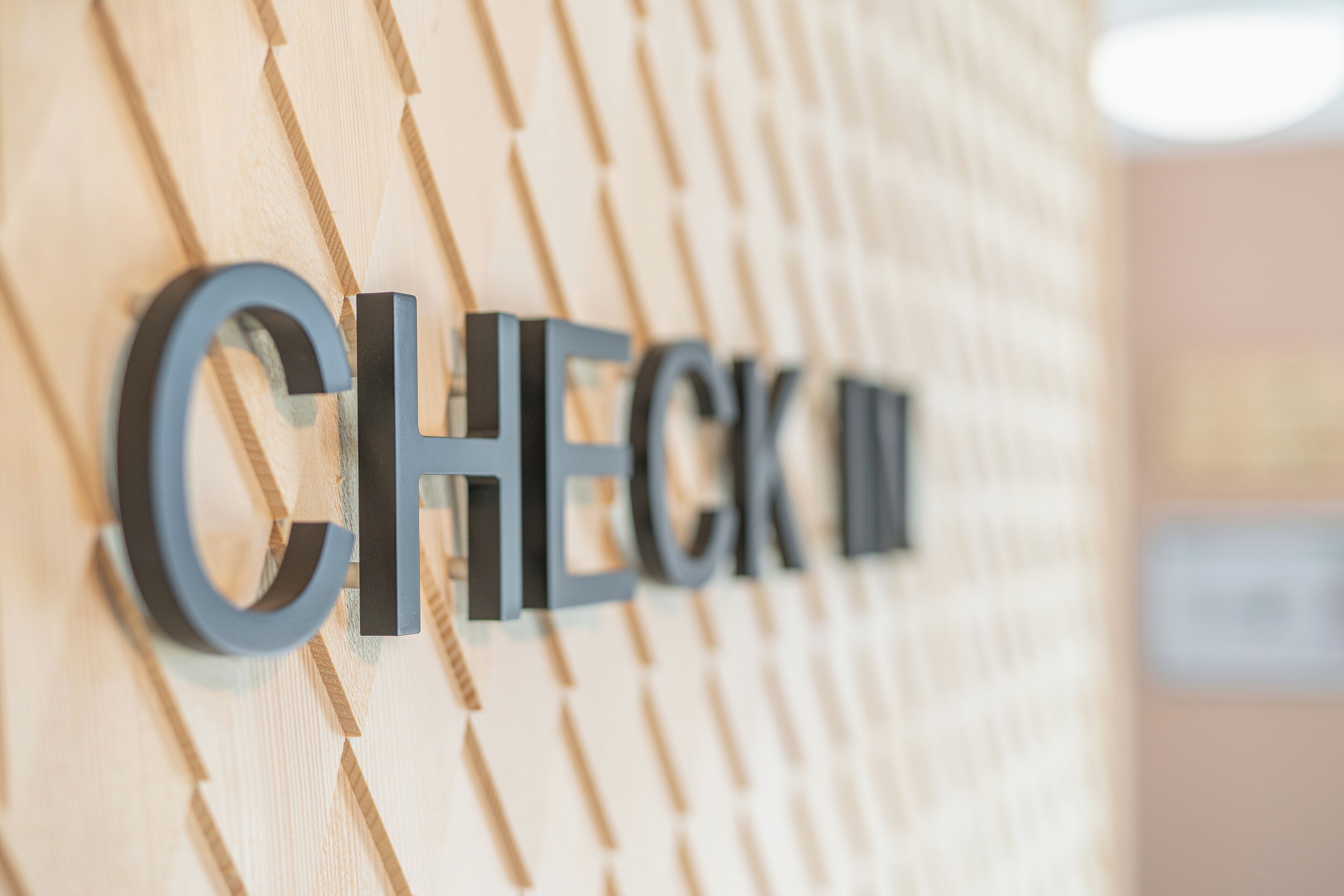 A wall with the words "CHECK IN" in large, bold letters.