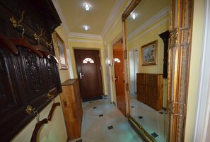 A hallway with a wooden door, a mirror, and a wooden cabinet. - Ferienhäuser Zum Höft 44 (Mönchgut-Granitz)