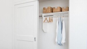 A bedroom with a bed, a closet with hanging clothes, and baskets on the shelf. - Book now Summer is here— Pet,2BR/2BA, 2 Parking (Newport Beach)