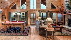 A spacious wooden cabin with a pool table, a sofa, and a fireplace. - WHEELCHAIR ACCESSIBLE, 4 King Suites, Close to Pigeon Forge, WOW Views! (Sevierville)