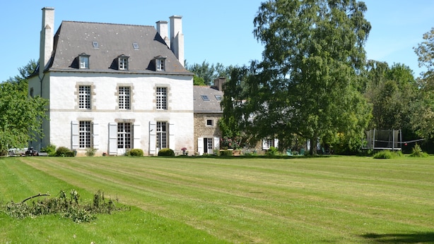 A large, historic building with a symmetrical facade, multiple chimneys, and a well-maintained lawn in front. - Malouinière des Trauchandières Saint-Malo (Saint-Jouan-des-Guerets)