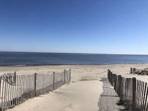 A sandy beach with a wooden fence leading to the water. - RARE Beachfront AND Wildlife Reserve Home in Broadkill Beach! (Milton)